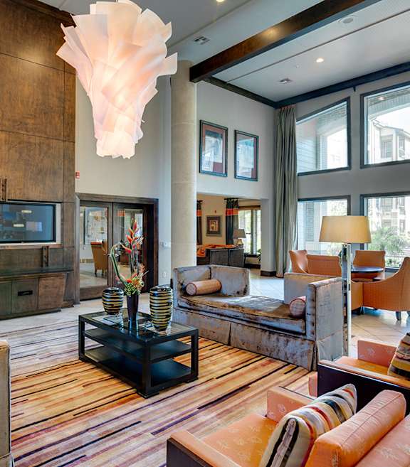 A modern kitchen with a dining area and a living room.
