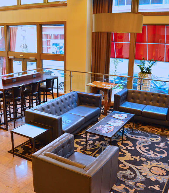 the lobby of a hotel with couches and a bar at The Laurel Apartments, Saint Louis, Missouri