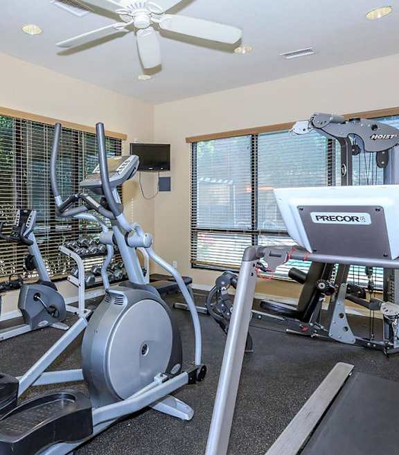 A fitness center with a treadmill, stationary bike, and a fan at Sereno Townhomes, Glendale, 85302.