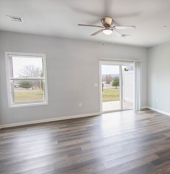 A room with a ceiling fan and a window.