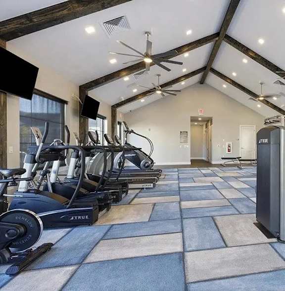 A spacious gym with a variety of exercise equipment.