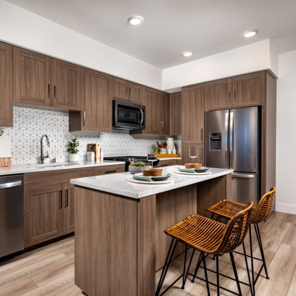 A modern kitchen with wooden cabinets and a white countertop at Citron Anaheim, CA