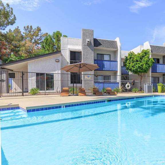 A swimming pool in front of a modern building.