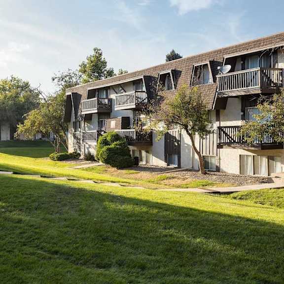 Exterior view of Trailgrove Apartments in Denver with classic architecture and well-maintained landscaping.