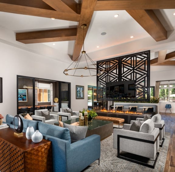 a living room with couches and chairs and a fireplace