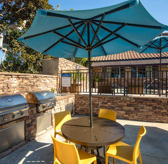 a patio with a table and chairs and an umbrella