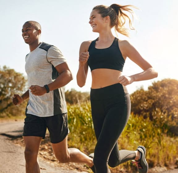 a man and a woman running down a road
