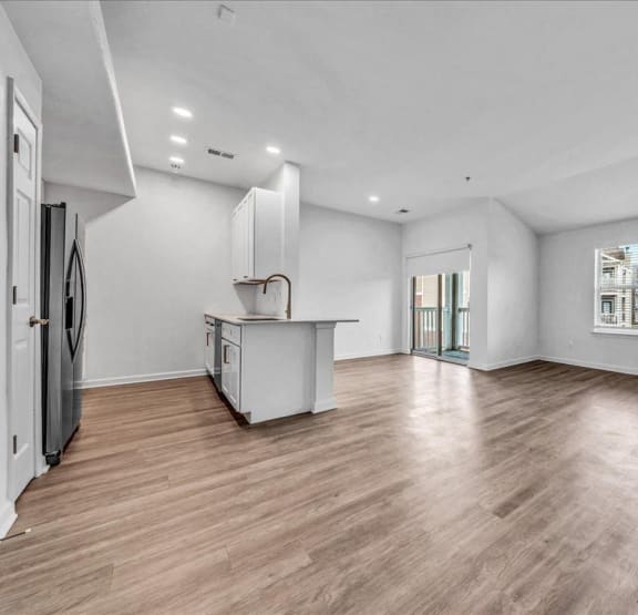 a living room with a coffee table and couch and painting on the wall at The Vinings Apartments in Richmond, VA 23234
