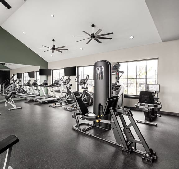 a spacious fitness center with cardio equipment and windows at Slate at Fishers District, Indiana, 46037