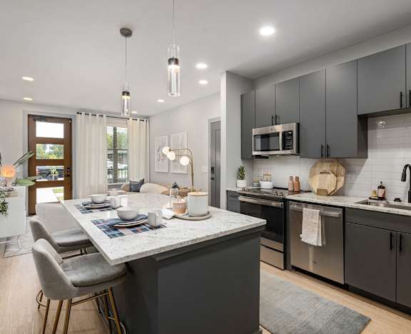 an open kitchen and dining area with a table and chairs