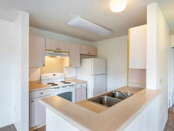 a kitchen with white appliances and a sink
