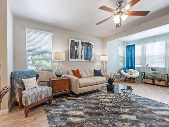 A living room with a sofa, armchair, and a coffee table.