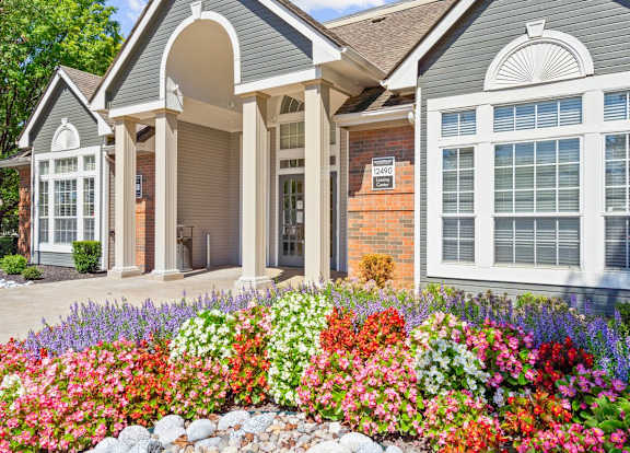 a sign for stonebrae apartment homes in front of flowers