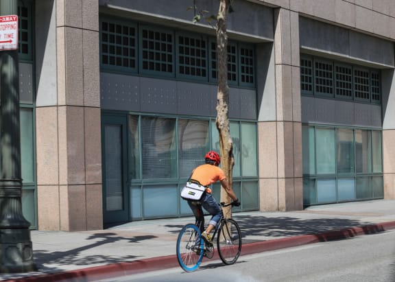 a man riding a bike down a city street