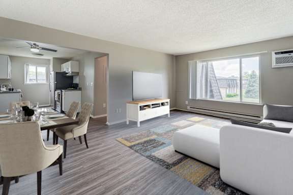 A living room with a couch, chairs, and a dining table.
