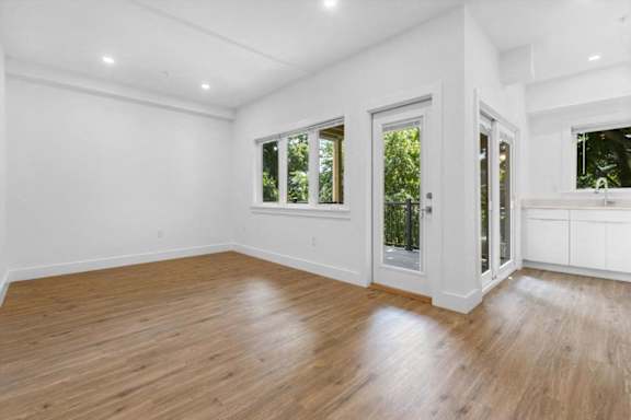 A room with wooden floors and white walls.