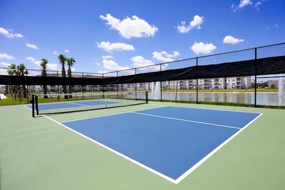 A tennis court with a blue surface and white lines.