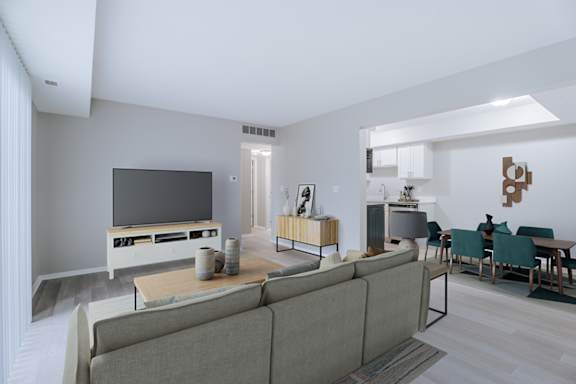 A modern living room with a grey sofa and a wooden entertainment center.