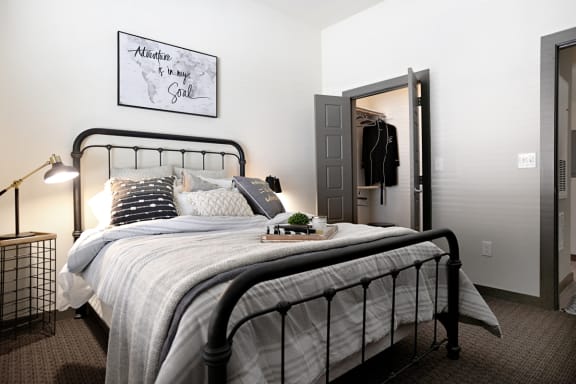 a bedroom with a bed and a closet at The Liberty Lofts, Gainesville, 76240