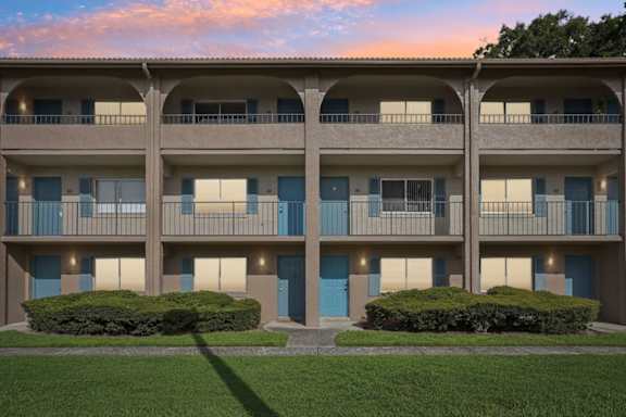 Apartment building with blue doors and windows.
