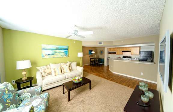 A living room with a couch, chair, and coffee table.
