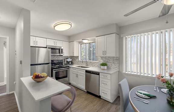A modern kitchen with a dining table and chairs.