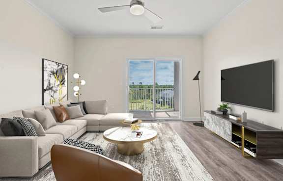 A modern living room with a large couch, a coffee table, and a flat-screen TV.