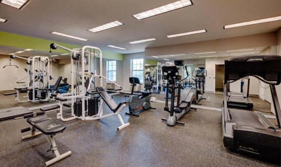 a gym with cardio equipment and weights on the floor  at Walkover Commons, Massachusetts