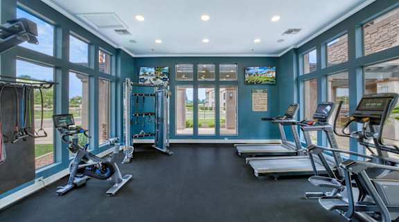 A gym with treadmills and exercise bikes.