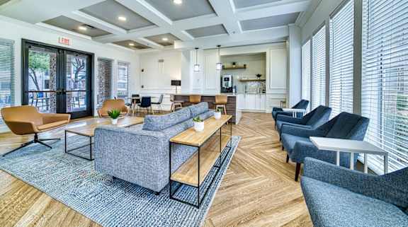 A spacious waiting room with a variety of seating options and a view of the street outside.