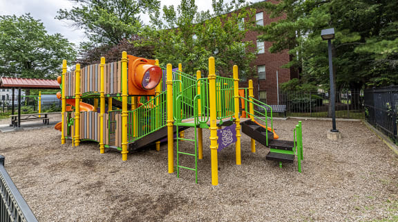 a playground in a park in front of a building