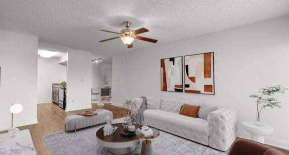 an open living room with furniture and a ceiling fan