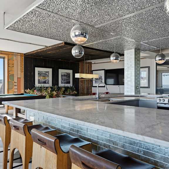 A black and white checkered floor in a room with a pool table.