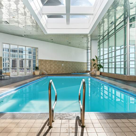a swimming pool in a large building with windows