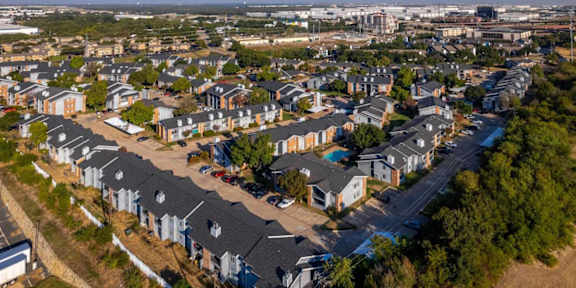 A bird's eye view of a residential area with houses and roads. at Logan Ridge Apartments, San Marcos, 78666
