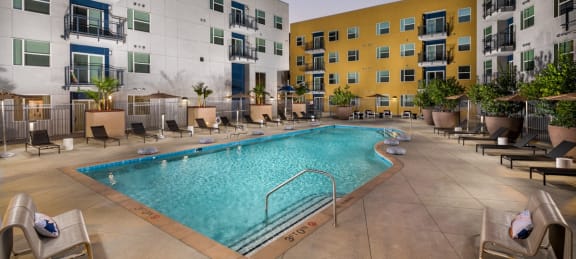 a swimming pool in the middle of an apartment building at Aston at Gateway Apartments, El Monte, California