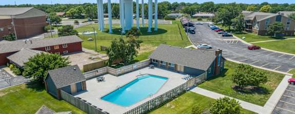 an aerial view of a pool and water tower in a neighborhood