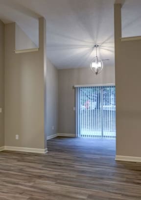 a kitchen and living room with hardwood floors and a ceiling fan