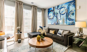 a living room with a large blue painting on the wall