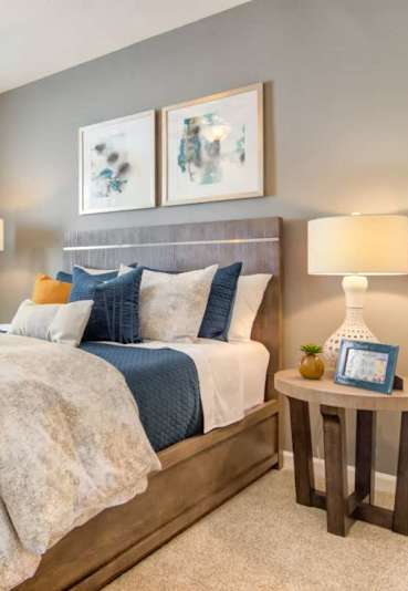 A bedroom with a large bed and a ceiling fan.