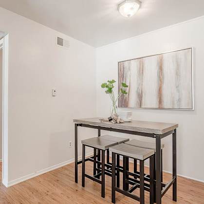 a dining room with a table and three stools