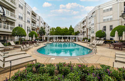 Swimming pool surrounded by lounge chairs and umbrellas at Oberlin Court, Raleigh, NC