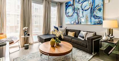 a living room with a large blue painting on the wall at Ascend Apollo Apartments, Largo, MD, 20774
