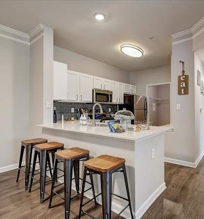 a kitchen with a breakfast bar and stools