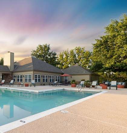a swimming pool with a house in the background