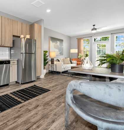 A modern kitchen with wooden cabinets and a stainless steel refrigerator.