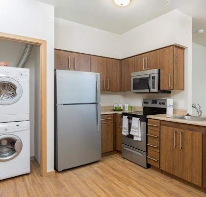 a kitchen with stainless steel appliances and wooden cabinets