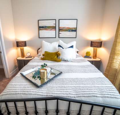 a bedroom with a bed and two lamps at The Century at Purdue Research Park-Student, West Lafayette, IN 47906