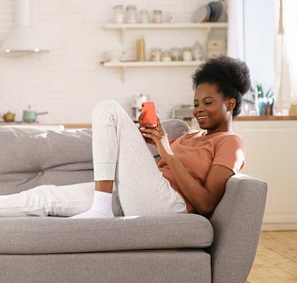 Lifestyle photo of woman at home on the couch at Portofino, Florida