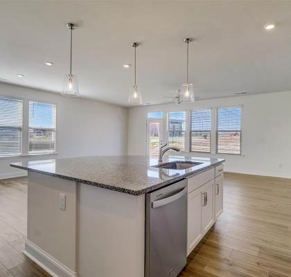 a kitchen and living room with a large island
